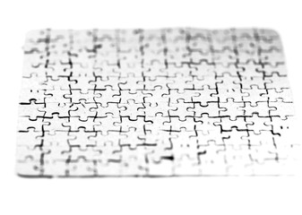 close up. blank card collected from puzzle pieces on a white sheet