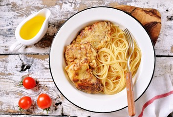 meat pieces fried in a mixture of flour and eggs with spaghetti