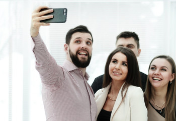 business colleagues taking a selfie in a modern office