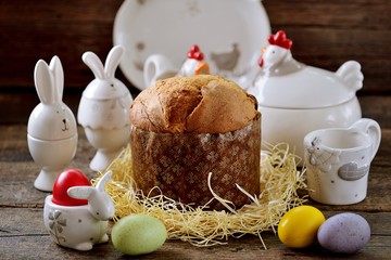 Traditional Easter food - eggs and Easter cake on an old wooden table. Easter background.