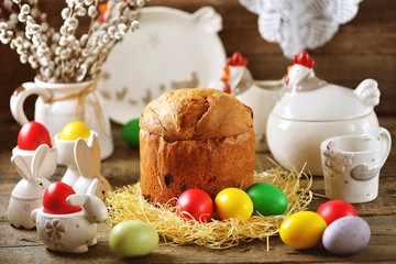 Fototapeta na wymiar Traditional Easter food - eggs and Easter cake on an old wooden table. Easter background.