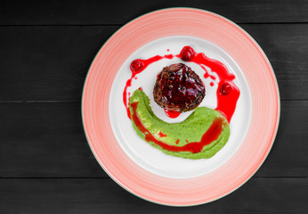Grilled beef steak meat with berries and avocado sauce in plate. Hot Meat Dishes. Top view, flat lay
