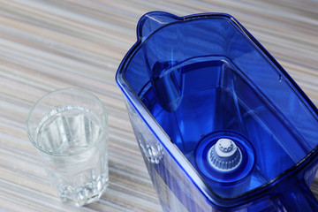 Filter for cleaning drinking water on the table in the kitchen. Purification of drinking water at home.