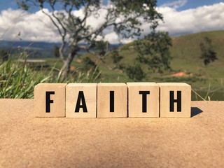 Religious concept - FAITH written on wooden blocks.