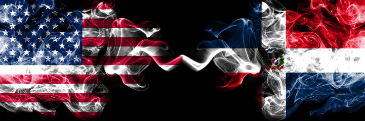 United States of America vs Dominican Republic smoky mystic flags placed side by side. Thick colored silky smoke flags of America and Dominican Republic