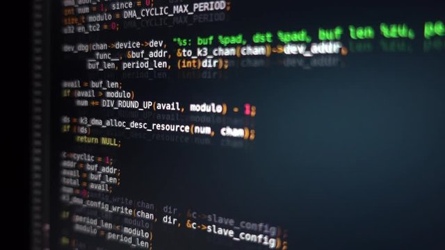 The program code scrolls on the computer screen