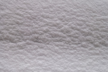 close up of fresh texured winter snow covering background wall