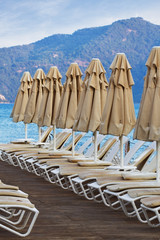 Many folded parasols over the Aegean sea