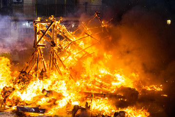 Valencia, Spain - March 19, 2019: Detail of a Falla Valenciana burning between flames of fire.