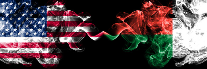 United States of America vs Madagascar, Madagascan smoky mystic flags placed side by side. Thick colored silky smoke flags of America and Madagascar, Madagascan