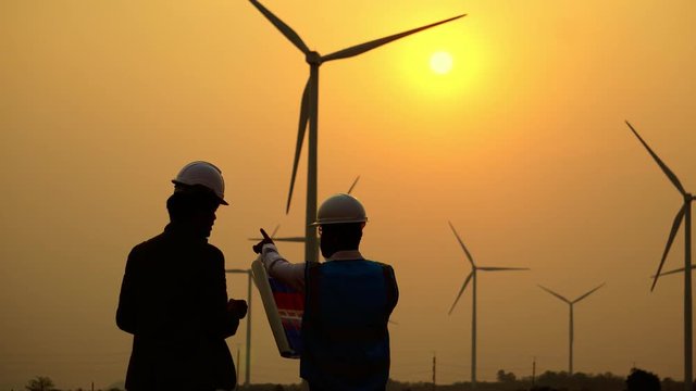 The two Asian engineers are checking the system for wind turbines footage 4K