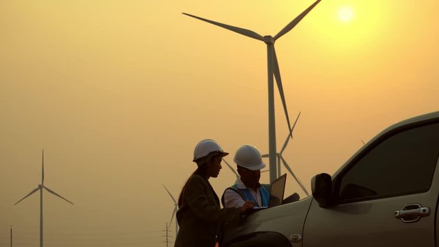 The two Asian engineers are checking the system for wind turbines footage 4K