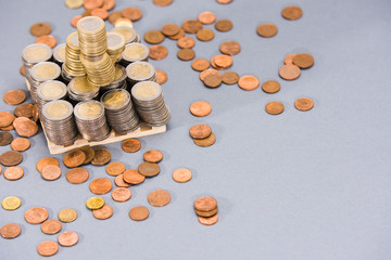 Stack of EURO coins with coppers coins around on clear background
