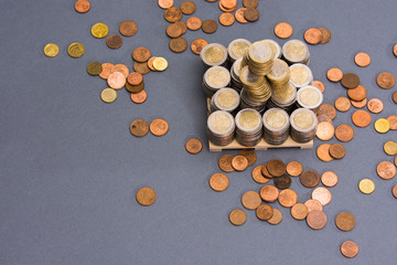 Stack of EURO coins with coppers coins around on clear background