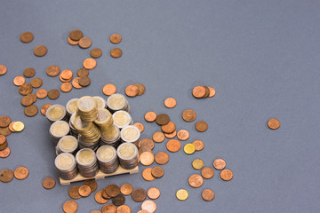 Stack of EURO coins with coppers coins around on clear background