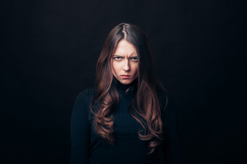 Fototapeta na wymiar Portrait of angry upset woman isolated on black background