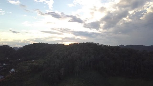 Raising up over the beautiful mountains to reveal an amazing halo effect sunset in Mae Hong Son Northern Thailand