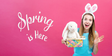 Spring is here message with young woman with Easter basket