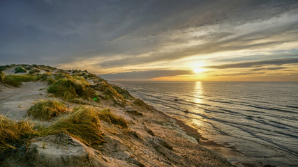 Fototapeta premium Sunset with Clouds Reflections at the South Coast of Brazil during Road Trip in South America