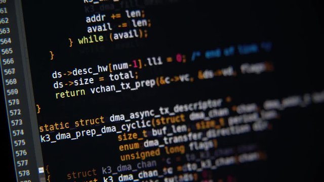 The program code scrolls on the computer screen