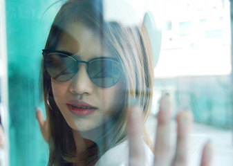 close-up beautiful woman smile portrait and looking glass, Blur and soft light foreground.