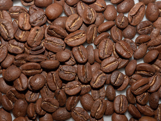 Extreme close up of coffee beans against white background, details of coffee beans