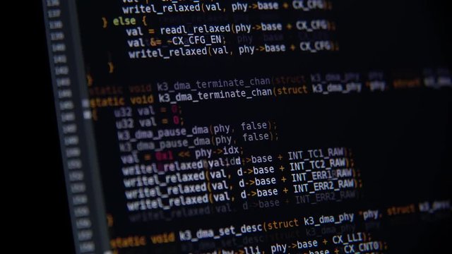 The program code scrolls on the computer screen
