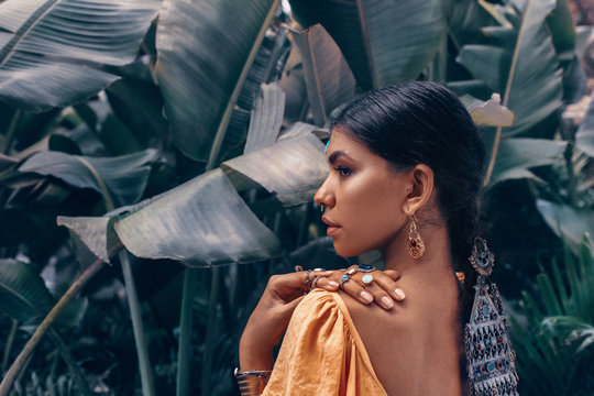 Close Up Of Beautiful Young Fashionable Woman With Make Up And Stylish Boho Accessories Posing On Natural Tropical Background