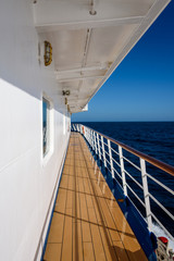View of blue sky and blue ocean on sunny day from outside deck of cruise ship, Atlantic Ocean