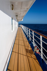 View of blue sky and blue ocean on sunny day from outside deck of cruise ship, Atlantic Ocean