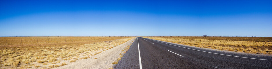 Panorama of straight road through the dessert of Australia on the Flinders Hightway, Quennsland...
