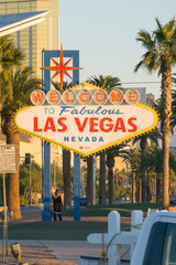 early morning sun illuminating las vegas sign and vegas skyline behind it © digidreamgrafix