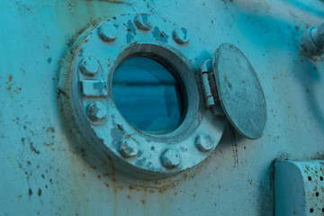 rusty old bathyscaphe with windows as background