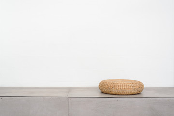 Weave sitting chair on concrete floor with white wall
