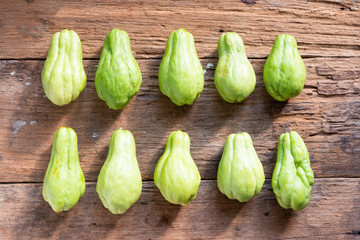 Fresh chayote fruits (Sechium edulis) on wood background