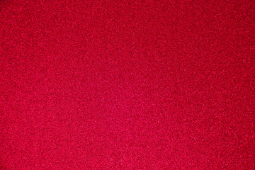 An abstract red background made of twinkling glitter that is great for a background for Christmas and other celebrations.