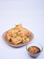 Fried tofu or tahu with petis sauce and chili, javanese traditional indonesian snack