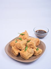 Fried tofu or tahu with petis sauce and chili, javanese traditional indonesian snack