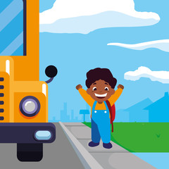 happy little black schoolboy with schoolbag in the bus stop