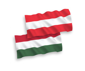 National vector fabric wave flags of Austria and Hungary isolated on white background. 1 to 2 proportion.