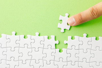 ジグソーパズル　White jigsaw puzzle on green background