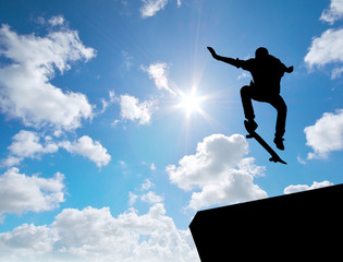 Skater jump silhouette and blue sky.