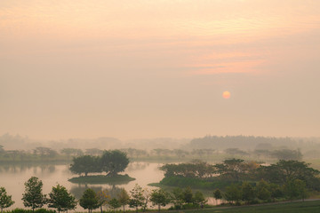 Defocus landscape sunrise sky over the lake in forest in the morning sunlight with fog and blurred backgrounds.
