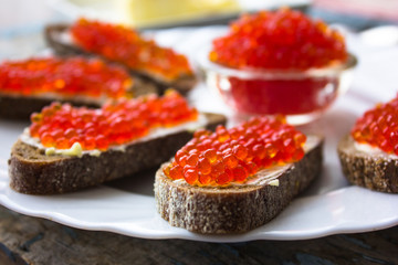 red caviar on black bread with butter. Healthy food. Fish appetizer.