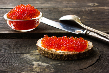 red caviar on black bread with butter. Healthy food. Fish appetizer.