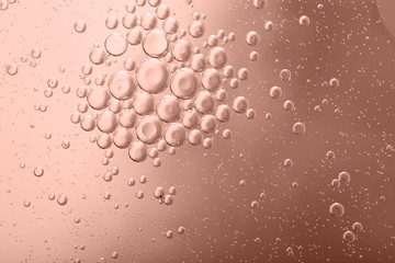 Blurred abstract background. Abstract pink circles and drops of different sizes, the texture of the liquid. Cropped shot, horizontal, blurred, free space, nobody, toned pink.