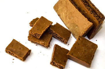 milky, porous chocolate on a white background