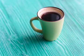 Closeup coffee mug on wooden background.