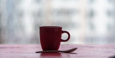 Closeup coffee mug on wooden background.