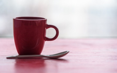 Closeup coffee mug on wooden background.
